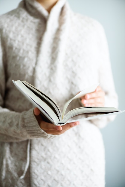 Young girl reading opened book.  lifestyle and school concept