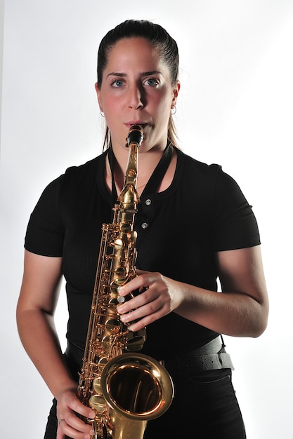 Young girl rehearses music lesson with saxophone