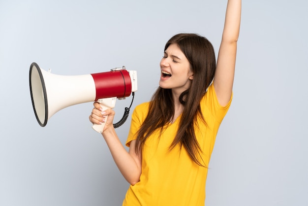 Young girl shouting through a megaphone to announce something