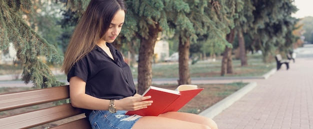 A young girl sits on a bench in a park and makes notes Dressed in a free style Business woman talking on the phone with customers