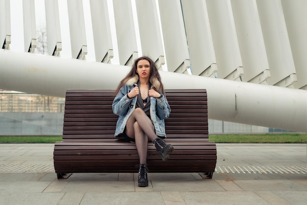 A young girl sits on a bench