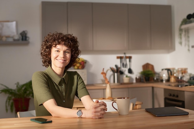 Young girl sitting in domestic kitchen