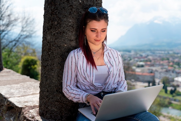 Young girl sitting working in her laptop