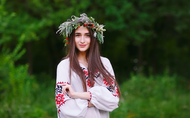 A young girl of Slavic appearance with a wreath of wild flowers on the MidSummer.