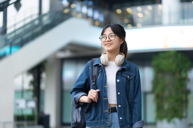 Young girl smile watching and using phone laptop headphones