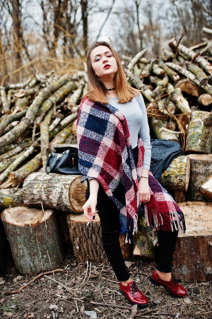 Young girl smoking cigarette in the forest