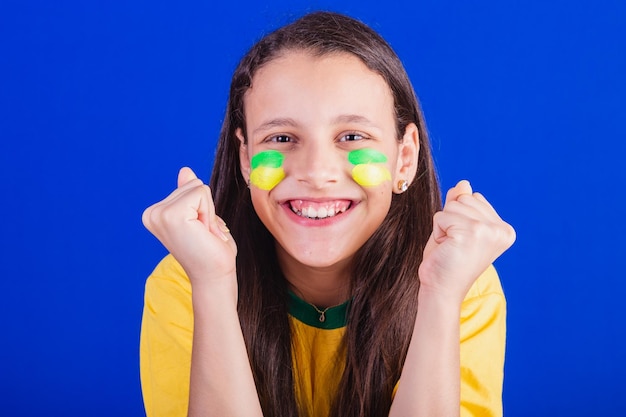 Young girl soccer fan from Brazil closeup photo celebrating