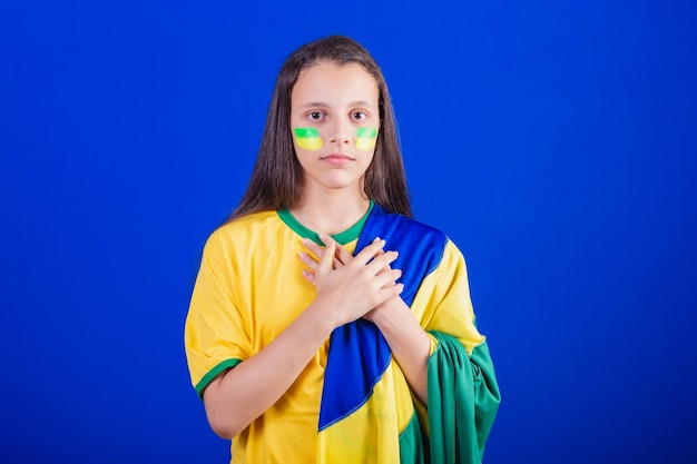 Young girl soccer fan from Brazil dressed in flag singing national anthem Gratitude