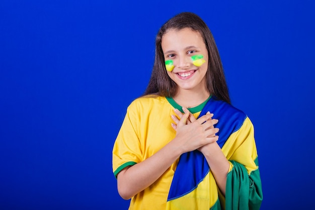 Young girl soccer fan from Brazil dressed in flag singing national anthem Gratitude