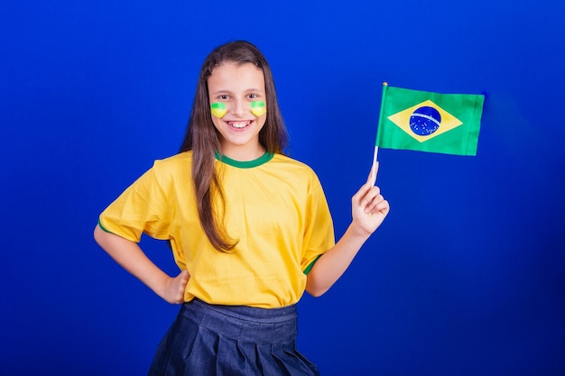 Young girl soccer fan from Brazil holding brazil flag