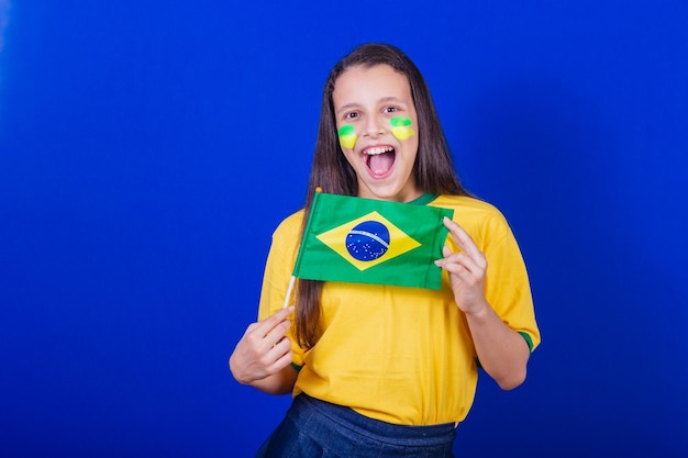 Young girl soccer fan from Brazil holding brazil flag