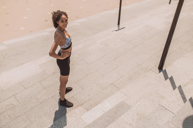 A young girl in sportswear looking confident and contented