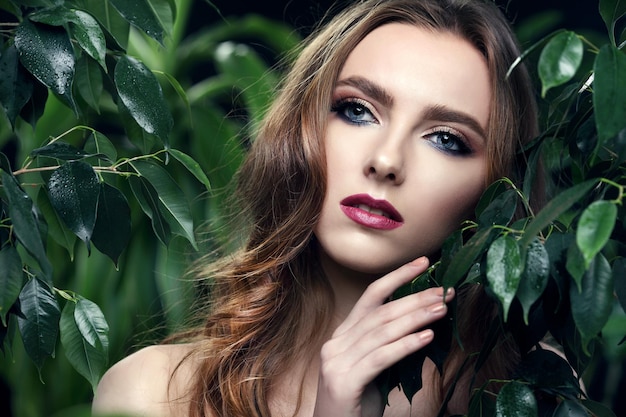 Young girl standing by the leaves