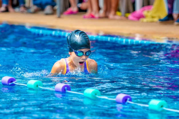 Young girl swimmers practicing lap swimming