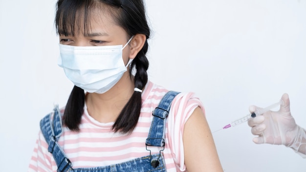 Young girl taking a vaccination. Virus protection.on white background.