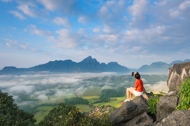 Young girl travels on high mountain in Vang-Vieng, Laos. 