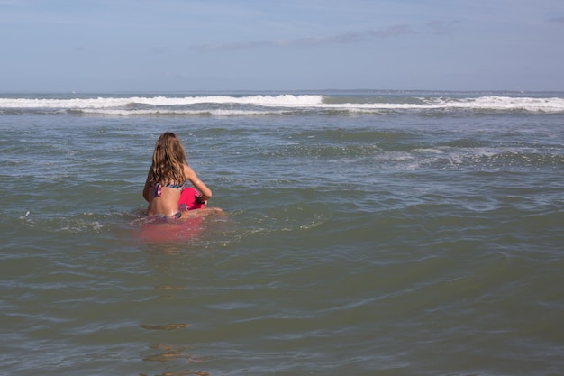 young girl behind on water sea beach