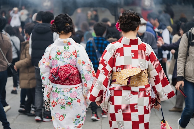 Young girl wearing Japanese kimono standing in front of Sensoji Temple 