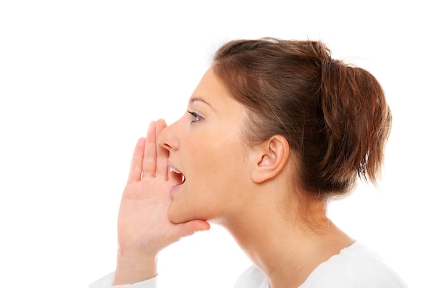 a young girl whispering over white background