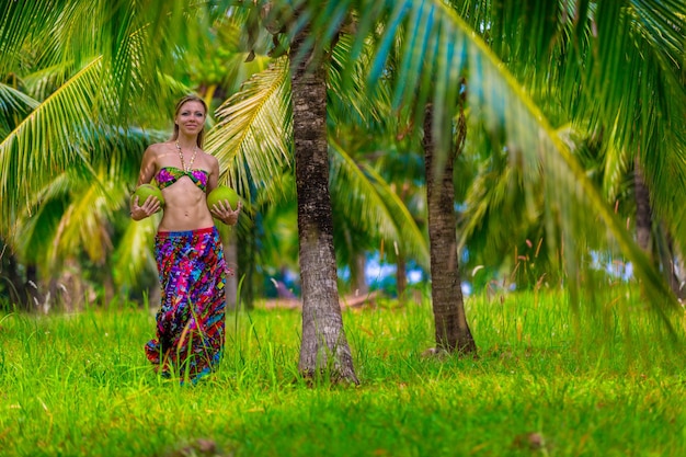 Young girl with coconuts