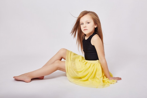 Young girl with long hair posing on a white background. Beautiful face and smile. Russia Sverdlovsk, 9 January 2019