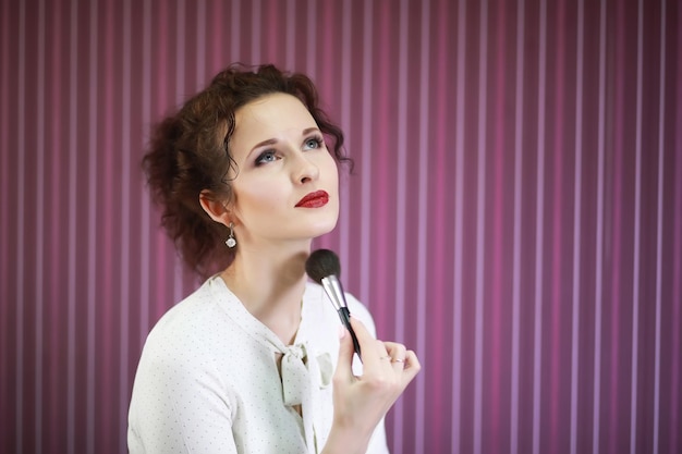 Young girl with a makeup artist