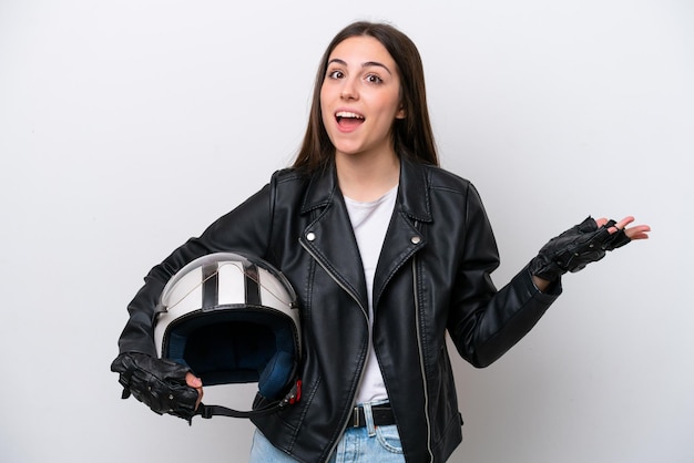 Young girl with a motorcycle helmet isolated on white background with shocked facial expression