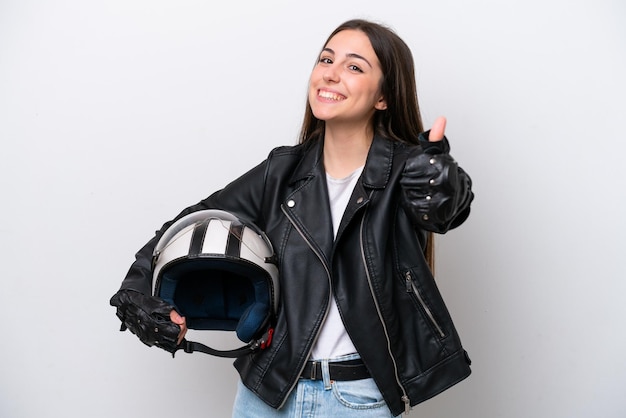 Young girl with a motorcycle helmet isolated on white background with thumbs up because something good has happened