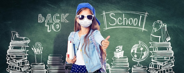 Young girl with protection mask against corona virus at school