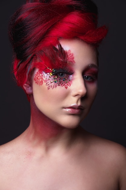 Young girl with red hair and creative ingenious makeup