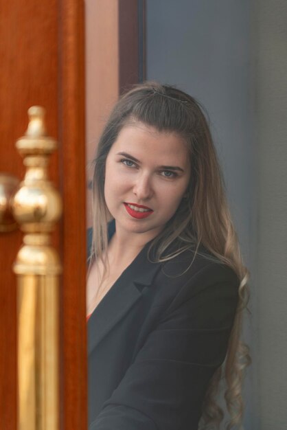 Young girl with red lipstick wears black business suit Portrait of successful business woman