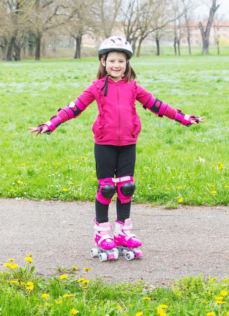 Young girl with roller skates in the park