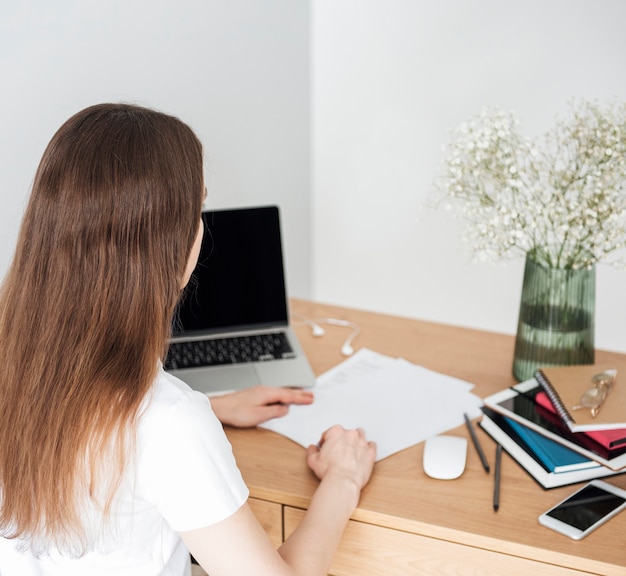 Young girl working at home office at the table