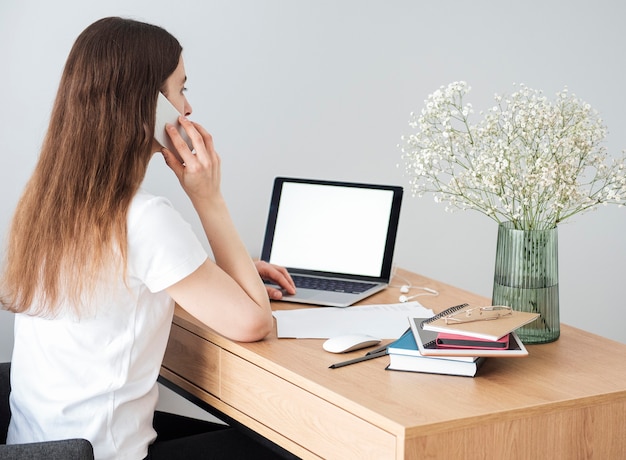 Young girl working at home office at the table