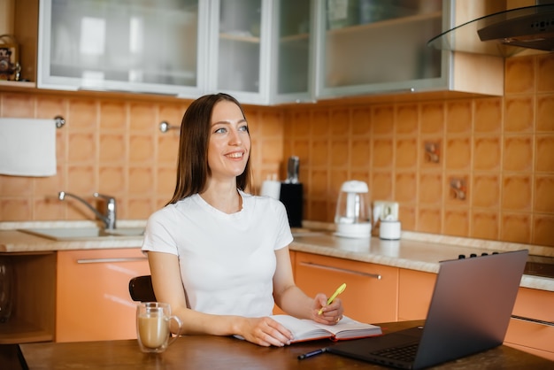 A young girl works at home on a remote site. Distance learning