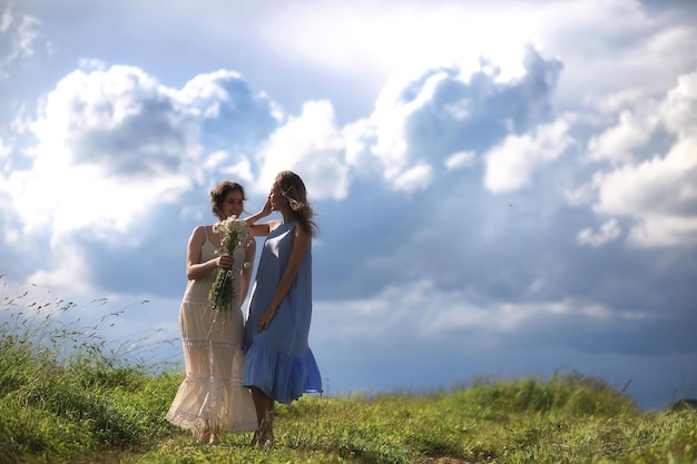 Young girls are walking in the field