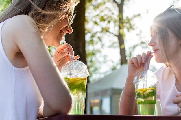 Young girls drinking mojito