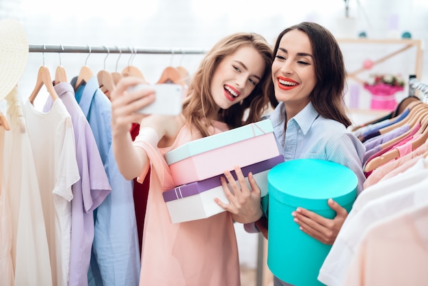 Young girls on shopping. choose clothes in the store.