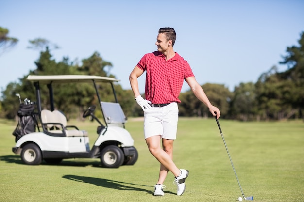 Young golfer with hand on hip