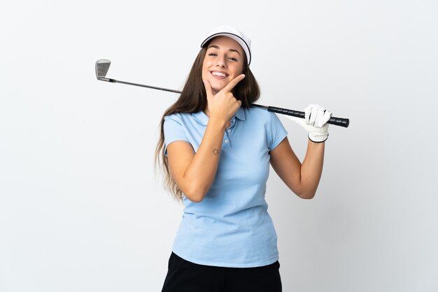 Young golfer woman over isolated white wall happy and smiling