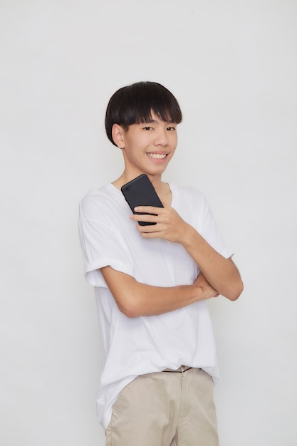 Young good looking Asian Man holding of mobile phone on white studio background