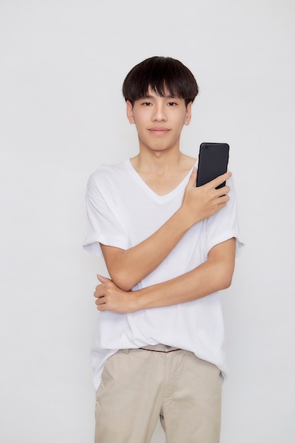 Young good looking Asian Man holding of mobile phone on white studio background