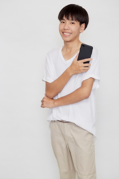 Young good looking Asian Man holding of mobile phone on white studio background