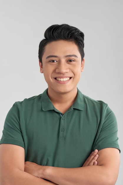 Young good looking man standing wearing a green tshirt White background