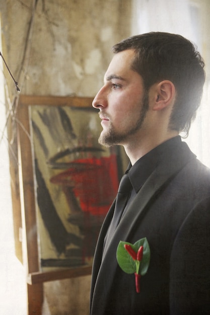 Young groom in vintage interior waiting for bride