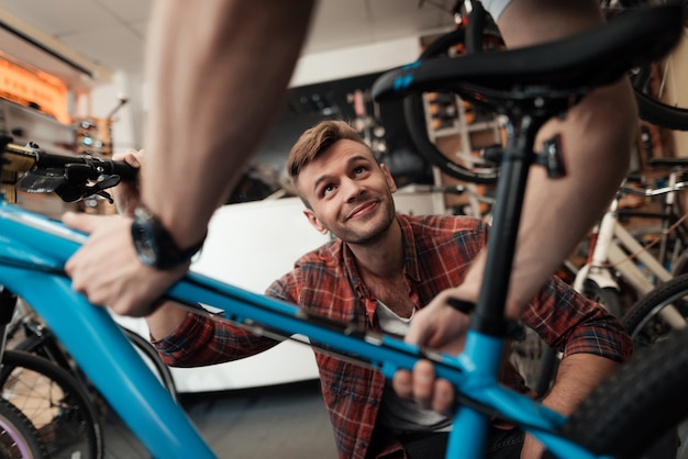 Young Guy Bring Bicycle to Repair in Workshop.