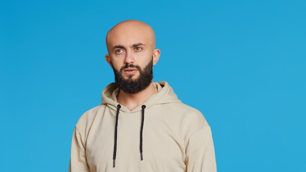 Young guy gesturing no sign over studio background