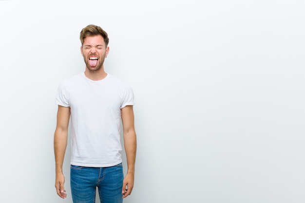 young guy rebellious sticking tongue out