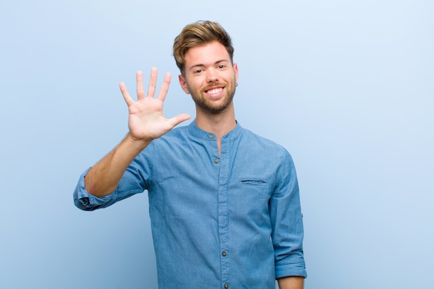 young guy showing number five or fifth with hand forward