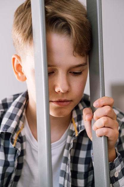 A young guy with an angry or offended expression Upset teenager holding onto handrails